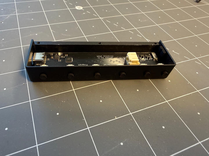 The assembled device showing the PCB mounted in the aluminum case.